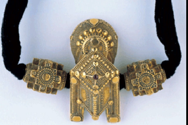 Gold tali set with ruby, flanked by gold beads. Tamil Nadu; 19th century