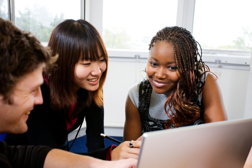 Students look at a computer together