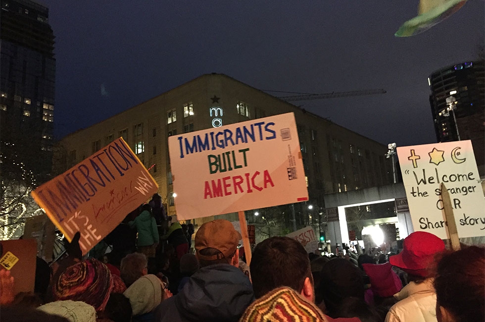 A sign that reads "Immigrants Built America" at a rally in Seattle, Washington.