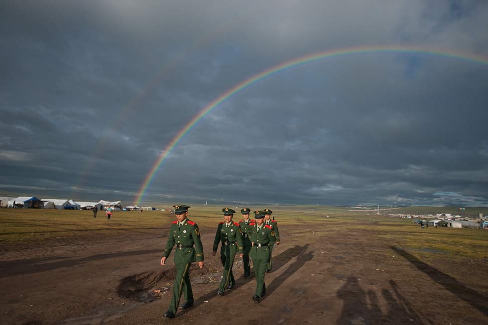 Nakchu, at the crossroads of Route 317 and the Qinghai-Lhasa highway, holds the largest Horse Festivals in Tibet. The double rainbows arcing over a group of Chinese policemen were an auspicious sign for 2011's celebration; in 2010, it was cancelled due to political unrest. (Michael Yamashita)