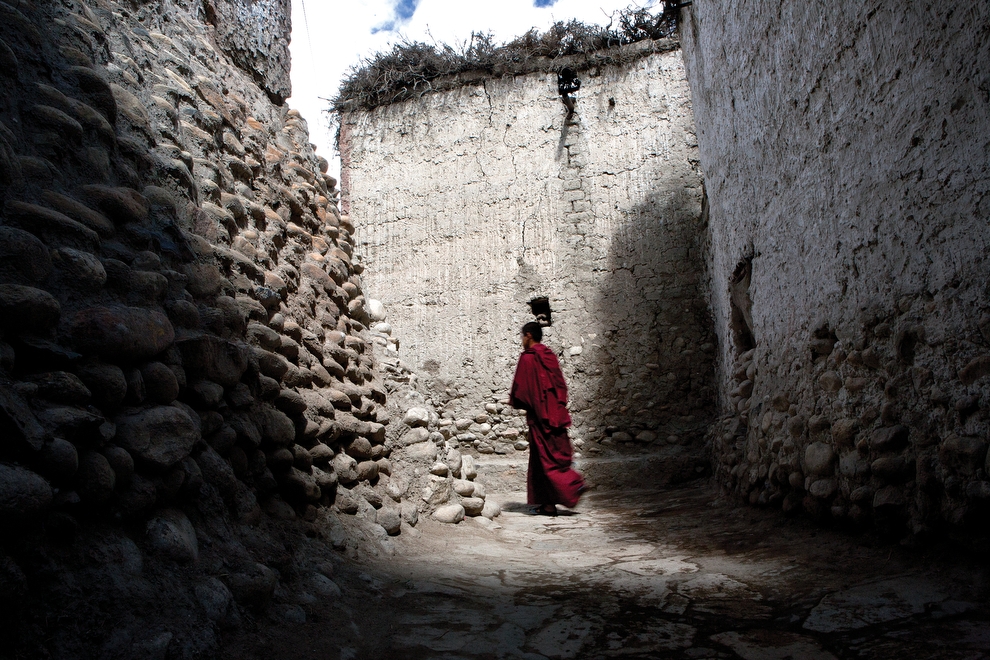 A monk walks through the alleyways of Lo Manthang. (Taylor Weidman)