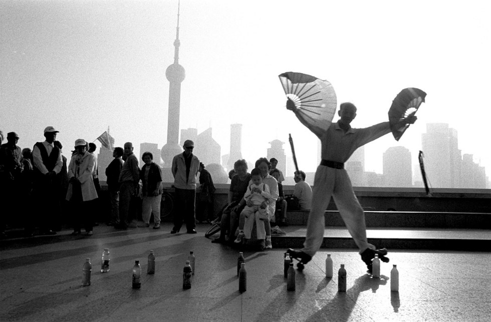 A retired circus performer executes early morning roller skating tricks on the Huang Pu River in Shanghai. (Ryan Pyle)