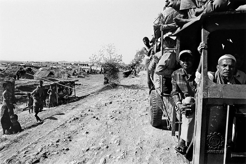 Displaced Rohingya ride in a three-wheeled tuk tuk between internally displaced person camps in a remote area outside of Sittwe, Myanmar. It is estimated that over 120,000 Rohingya have been displaced. (Greg Constantine)