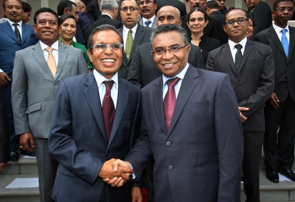 East Timor's new Prime Minister Rui Araujo (R) and President Taur Matan Ruak (L) shake hands as they pose for a group photograph after a swearing ceremony in Dili on February 16, 2015. VALENTINO DE SOUSA / AFP / Getty Images  