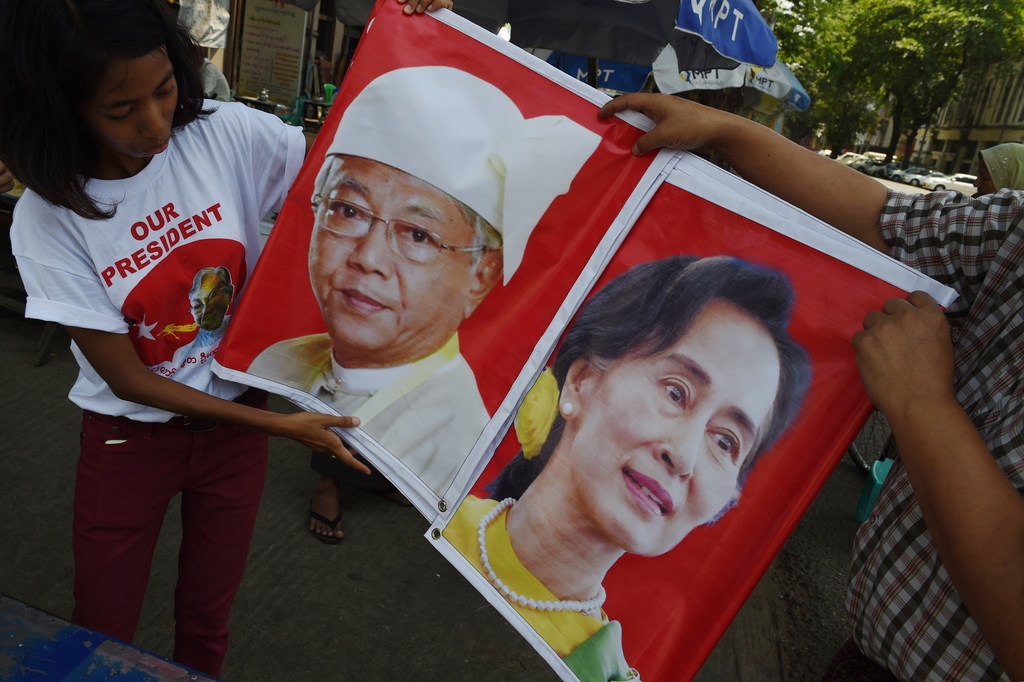 Supporters of the National League for Democracy (NLD) hold a banner displaying the portraits of new Myanmar President Htin Kyaw (L) and democracy icon Aung San Suu Kyi (R) in Yangon on April 10, 2016 ahead of the Thingyan new year festival. (ROMEO GACAD/AFP/Getty Images)
