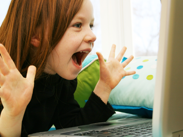 A child reacts in excitement (killerb10/iStockPhoto)