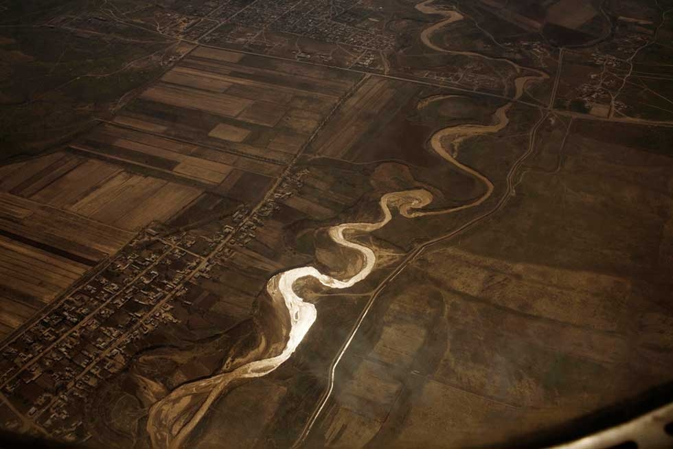 Overhead view of the Syr Darya river in Uzbekistan, with an irrigation canal on the right. From "Two Rivers." (Carolyn Drake)