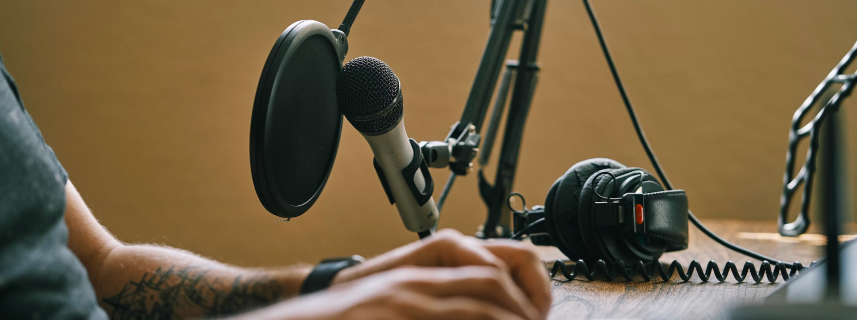 Person with microphone at podcast setup