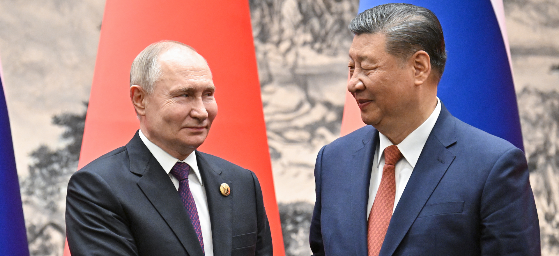   Russia’s President Vladimir Putin and China’s leader Xi Jinping shake hands during a signing ceremony following their talks in Beijing on May 16, 2024. (Photograph distributed by the Russian state agency Sputnik.)