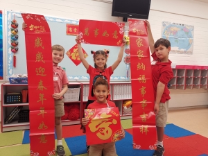 First-graders holding the Chinese Spring couplet on the Lunar New Year day