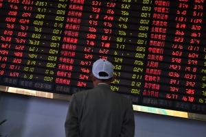 Investors monitor stock price movements at a securities company in Shanghai on May 8, 2019