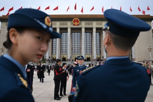 Military delegates gather outside the Great Hall of the People after the closing session of the National People's Congress (NPC) in Beijing on March 13, 2023