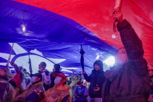 Supporters hoist a giant Taiwan national flag during a campaign rally of Kuomintang (KMT) ahead of Taiwan's presidential election, in Taipei on December 23, 2023