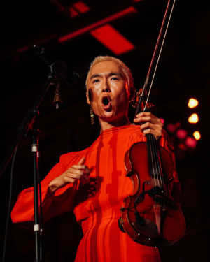 a headshot of artist yuniya edi kwon playing the violin