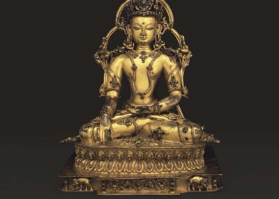 Buddha Akshobhya, 14th century, Central Tibet. Gilt copper alloy with inlays of semiprecious stones. 11 x 9 1/16 x 6 ½ in. (28 x 23 x 16.5 cm). Museum Rietberg Zürich, on long-term loan from The Berti Aschmann Foundation, BA 32. Photograph by Peter Schälchli.