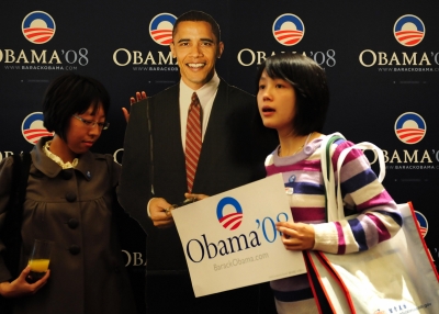 Young Chinese stand beside a lifesize cutout image of Barack Obama after he won the US presidential race at an election day event organized by the US embassy in Beijing on Nov. 5, 2008. (FREDERIC J. BROWN/AFP/Getty Images)