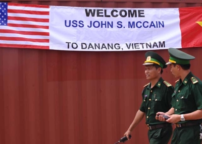 Two Vietnamese border-guard officers walk past a banner welcoming the port call by the US destroyer USS John S. McCain at Tien Sa port in the central costal city of Danang on August 10, 2010. (Hoang Dinh Nam/AFP/Getty Images) 