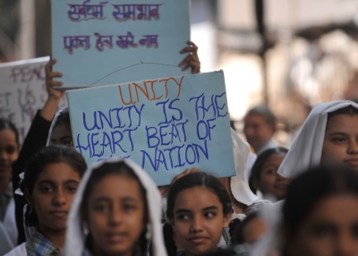 In Mumbai on Sept. 29, 2010, Indian schoolgirls hold signs advocating for tolerance as they march with a peace rally on the eve of the Babri Masjid mosque verdict. (Punit Paranjpe/AFP/Getty Images)