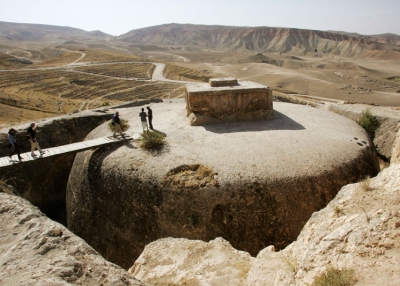 Members of a French archaeological team walk on top of a giant 4th century Buddhist stupa cut into a mountain in Samangan province, Afghanistan, in 2006. A similar historic site to the south and east in Mes Aynak is now at risk from a copper mine. (John Moore/Getty Images) 