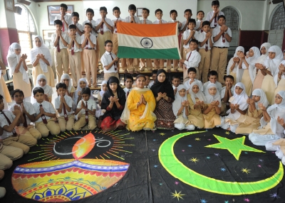 Students and teachers from the Anjuman-E-Islam school pose with Hindu and Islamic religious designs as they pray for a peaceful solution to the Ayodhya Ram Mandir and Babri Masjid issue in Ahmedabad on September 23, 2010. (Sam Panthaky/AFP/Getty Images)