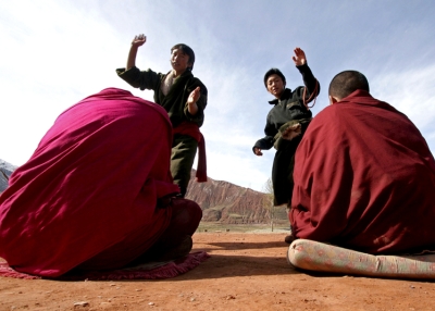 Students take part in a debate about Buddhism doctrine outdoors at the Jigmei Gyaltsen School on October 25, 2005 in Maqin County of Guoluo Prefecture, Qinghai Province, northwest China. (China Photos /Getty Images) 