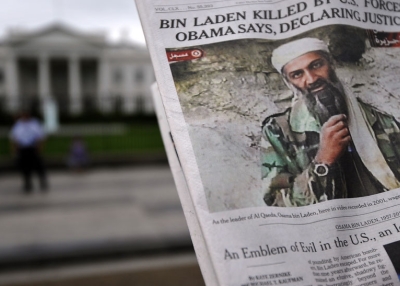 A man takes pictures of the front page of a newspaper featuring a picture of Al-Qaeda leader Osama bin Laden, in front of the White House in Washington, DC, on May 2, 2011. (Jewel Samad/AFP/Getty Images)