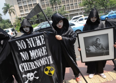 Activists from environmental action group Greenpeace carry portraits of victims from the 1986 Chernobyl nuclear plant disaster during an anti-nuclear protest outside Indonesia's Ministry of Energy and Mineral Resources in Jakarta on April 26, 2010 marking the 24th anniversary of the world's worst nuclear accident in Ukraine and to denounce Indonesia's plans to use nuclear energy. (Romeo Gacad/AFP/Getty Images)
