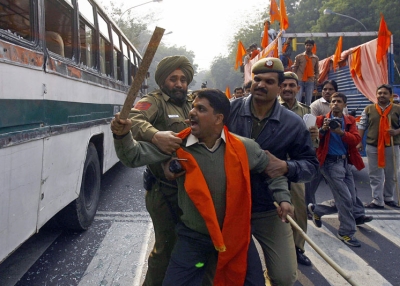Indian policemen try to restrain a Hindu activist (C) after he shattered the windows of a bus during a clash between Hindu and Muslim activists in New Delhi on Dec. 6, 2007. (Manpreet Romana/AFP/Getty Images) 