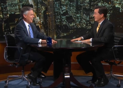 Republican presidential hopeful Jon Huntsman (L) talks to Stephen Colbert on the 'Colbert Report' October 24, 2011.