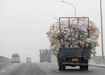 A truck containing used plastic bottles travels along a highway covered in haze in Beijing on December 5, 2011. (Liu Jin/AFP/Getty Images)