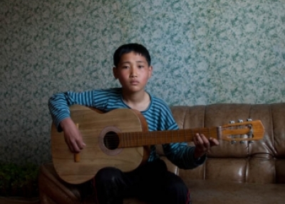 Beneath portraits of North Korea’s first two leaders, a boy plays his guitar before going to school. “North Koreans aren’t the robots they are often portrayed as in Western newspapers and magazines,” says photographer Eric Lafforgue.