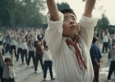 Wang Han (played by Liu Wenqing) leads his class in exercises as seen in 11 FLOWERS, a film by Wang Xiaoshuai. A First Fun Features release.