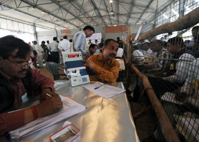 An election officer (2nd from left) shows an electronic voting machine to poll agents during vote counting at a counting center in Ghaziabad, Uttar Pradesh on March 6, 2012. (Prakash Singh/AFP/Getty Images) 