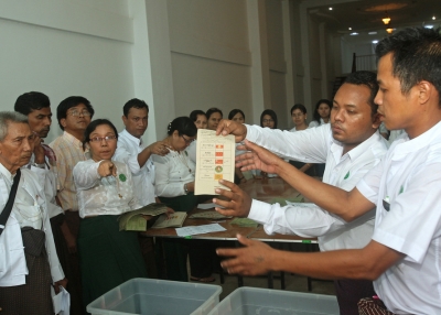 Election commission officials in Myanmar show a ballot paper on April 1, 2012 during counting at a polling station at a Yangon constituency during parliamentary by-elections. (Ye Aung Thu/Getty Images)