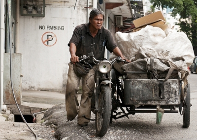 A cardboard collector in the back streets of Kuala Lumpur, Malaysia on May 15, 2012. (Photosightfaces/Flickr)