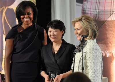 U.S. first lady Michelle Obama (L) and U.S. Secretary of State Hillary Clinton (R) pose with International Women of Courage Award-winner Guo Jianmei, a Chinese lawyer and rights activist, at the Department of State in Washington, DC on March 8, 2011. (Roshan Nebhrajani/Medill DC/Flickr)