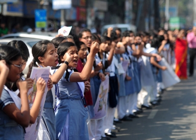 School girls form a human chain as they participate in a One Billion Rising rally in Dhaka, Bangladesh on February 14, 2013. (Munir Uz Zaman/AFP/Getty Images)