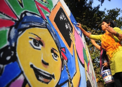 A Bangladeshi art student paints on a wall in front of the Shahid Minar in preparation for Language Martyrs Day and International Mother Language Day in Dhaka on Feb. 20, 2012. (Munir Uz Zaman/AFP/Getty Images)