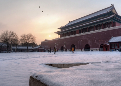On a snowy day tourists stop for photos at the Forbidden City in Beijing, China on February 8, 2014. (Nathan Quarles/Flickr)