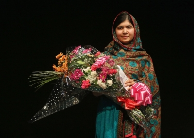 After being announced as a recipient of the Nobel Peace Prize, Malala Yousafzai holds a bouquet of flowers given to her on behalf of the Pakistani Prime Minster during a press conference at the Library of Birmingham in Birmingham, England, on Oct. 10, 2014. (Christopher Furlong/Getty Images)