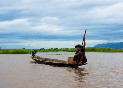 A man sets out early to fish in the waters of Inle Lake, Myanmar on June 19, 2014. (Lim Ashley/Flickr)