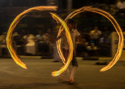 A fire dancer twirls double rings flames during the Navam Perahera Festival in Colombo, Sri Lanka on February 2, 2015. (Nazly Ahmed/Flickr)