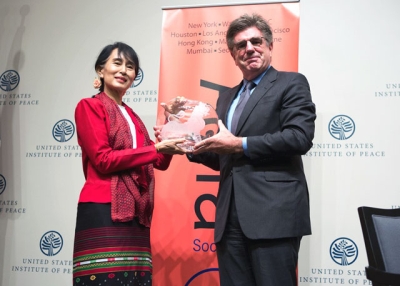 Asia Society Trustee Tom Freston poses with Aung San Suu Kyi after presenting her with the Asia Society's Global Vision award at the U.S. Institute of Peace in Washington, D.C., on Sept. 18, 2012. (Asia Society/Joshua Roberts)