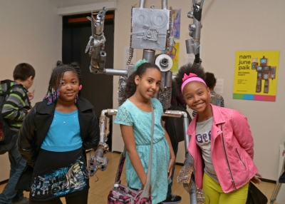 Student artists pose in the gallery in front of 4-2 D-2. (Elsa Ruiz)