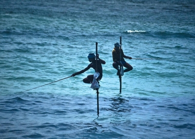 Two men fish on stilts with great skill and courage in Uva, Sri Lanka on May 10, 2015. (Bachellier Christian/Flickr)
