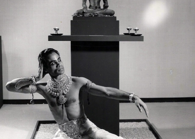 Nepali Dancer Bali Ram poses in front of a 15th-century sculpture, 'Avalokiteshvara', on loan from The Golden Monastery in Patan, Nepal at Asia Society's “The Art of Nepal.” (Asia Society)