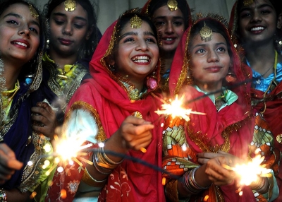 Indian schoolgirls share a light moment as they play with sparklers at a function in Amritsar on October 16, 2009, on the eve of the Diwali festival. (Narinder Nanu/AFP/Getty Images)