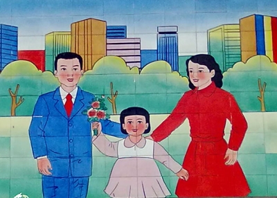 A mural in a village near Beijing stresses adherence to China's birth limits. (Eric Fish/Asia Society)