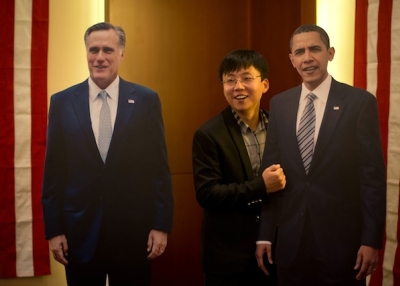 A man poses with cardboard cut-outs of U.S. President Barack Obama (R) and presidential candidate Mitt Romney (L) at a hotel during a U.S. presidential election results event organized by the American embassy in Beijing on Nov. 7, 2012. (Ed Jones/AFP/Getty Images)