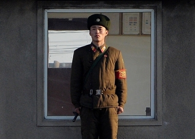 A North Korea soldier stands guard on the banks of the Yalu River which separates the North Korean town of Sinuiju from the Chinese border town of Dandong on the second anniversary of the death of former leader Kim Jong-Il, December 17, 2013. (Mark Ralston/AFP/Getty Images) 